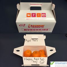 an open box of oranges sitting on top of a blue table next to a sign that says happy apricots