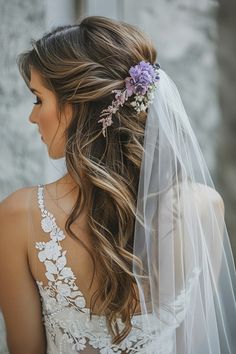 a woman wearing a veil with flowers in her hair