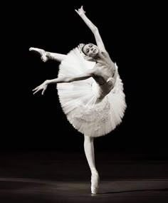 a black and white photo of a ballerina