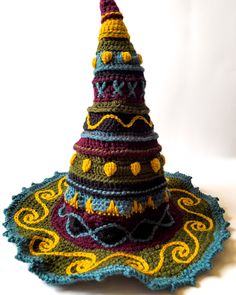 a crocheted multicolored christmas tree on a doily ornament