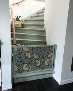 the stairs are painted green and decorated with floral designs, along with a basket on top