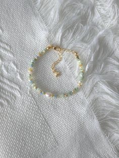 FOR OTHER DAINTY BEADED BRACELETS: https://www.etsy.com/ca/shop/ArtiChouXCanada?ref=seller-platform-mcnav%C2%A7ion_id&section_id=46088511 Bracelet Length: 13-18cm (5.1-7 inches) with a 14k gold filled or sterling silver extender. This bracelet features an assortment of pastel colors: green, yellow, blue, cream, white, and 18k gold filled or sterling silver seed beads. It also contains a freshwater pearl.  Thread may be visible since it is a handmade product   SIZING  Wrap a soft measuring tape s Cheap Green Bracelets With Tiny Beads, Pretty Seed Bead Bracelets, Handmade Pearl Bracelets, Silver And Gold Beaded Bracelet, Dainty Beaded Charm Bracelet With Round Beads, Green Seed Bead Bracelets, Bracelet Patterns Seed Beads, Pastel Beaded Bracelets, Small Glass Bead Bracelet