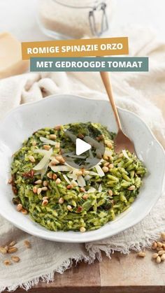 a white bowl filled with pesto and nuts