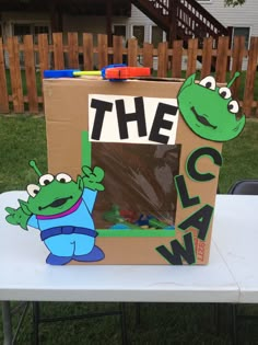 a cardboard box sitting on top of a table with the word the claw painted on it