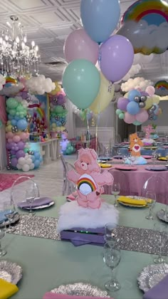 there is a table with balloons and other decorations in the room that has been set up for a birthday party