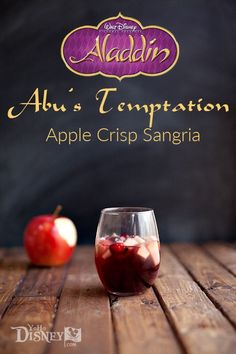 an apple and cranberry drink in a glass on a wooden table with the title alu's companion