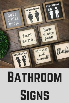 bathroom signs are displayed in wooden frames with the words restroom on them and below them