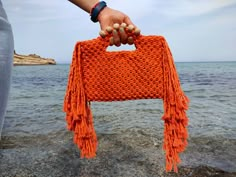 "Macrame Orange Fringed Wooden Beaded Bag, Clutch bag ,Handmade Bag ,Summer Mini Bag ,Macrame Small bag ,Christmas gift ,Tassel bag This macrame bag is made of 100% cotton yarn and is completely hand knitted. There are cute tassels on the sides of the bag. I created this awesome but cute orange wooden beaded hand knotted summer bag macrame clutch with love..You can use this gorgeous bag for your smartphone,small wallets and for your cocmetics. The style of this macrame bag  will blend seamlessly with your outfit for a modern look. You can also buy this cute macrame bag for yourself if you wish. If you wish, you can buy it as a housewarming gift, a birthday gift, a mother's day gift, a new year gift to your loved ones, and a perfect gift for your friends and bridesmaids. Created with 100% c Macrame Tas, Bag Macrame, Macrame Purse, Crochet Pillow Cover, Chunky Knit Throw, Fringe Bags, Macrame Bag, Bag Summer, Beaded Bag