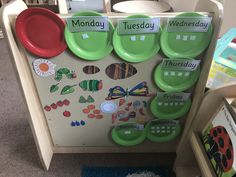 a child's play area with green plates and magnets