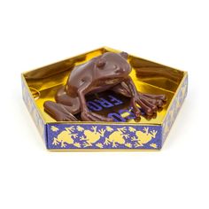 a chocolate frog in a blue and gold box