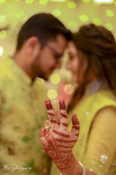 a man and woman standing next to each other with their hands in the shape of a peace sign