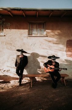 two men in mexican gauchos are playing guitars