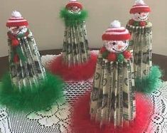 four snowmen made out of forks sitting on top of a table