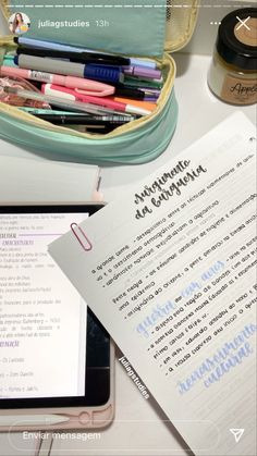 the contents of a bag are sitting next to an electronic device and notebook on a desk