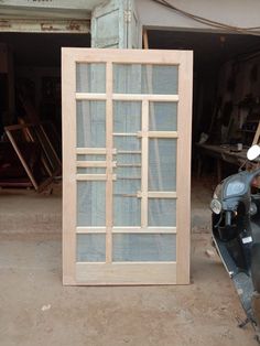 a motor scooter parked next to a wooden window