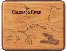 the colorado river map is engraved on a wooden plaque