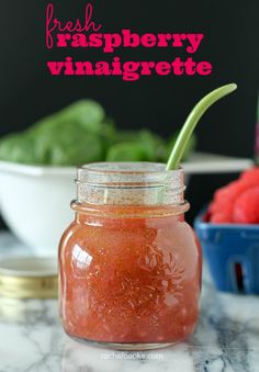 a jar filled with raspberry vinaigrete sitting on top of a counter