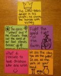 four different colored sticky notes on a wooden surface with words written in each one and the other