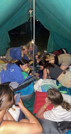 a group of people sitting in a tent