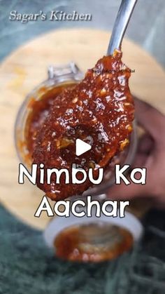 a person holding a spoon with food in it and the words nimbu ka aachar