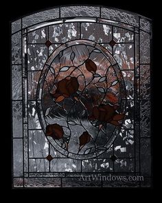 a stained glass window with red flowers in the center and leaves on it's side