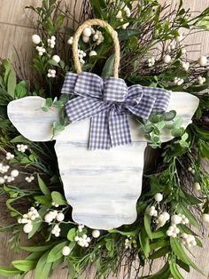 a wreath with a cow head and bow on it