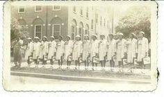 an old black and white photo of women in uniforms