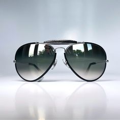 True Vintage B&L Bausch & Lomb Ray Ban Usa Black Leather Outdoorsman 62mm Aviator Sunglasses Circa 1950's. New Old Stock Nos. Unworn. Large Oversized. Unisex. No Original Case Included. G31 Dgm Glass Lenses W/ Double Gradient Silver Mirror. No Scratches. Pre-Bl Etching. Silver Metal Frames. Frames, Brow Bar & Temple Ends Have Genuine Leather. Top Of Brow Bar Reads B&L Ray-Ban U.S.A. 50’s 60’s Retro Ray-Ban Rayban Collector Pilot Metal Silver Aviators Odm 62 Men’s Women’s Military Classic Gift Luxury Silver Aviator Sunglasses, Luxury Silver Aviator Sunglasses With Mirrored Lenses, Luxury Silver Mirrored Aviator Sunglasses, Mirrored Aviators, Mirrored Aviator Sunglasses, Brow Bar, Cruise Wear, Ray Ban Aviators, Silver Mirror