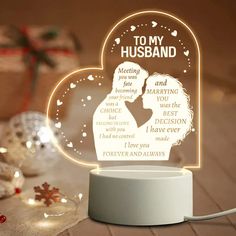 a personalized led lamp with a couple kissing in the middle, surrounded by christmas decorations