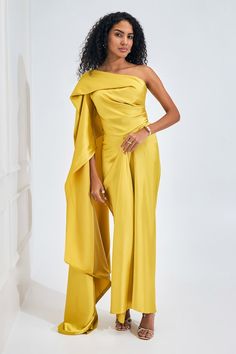 Electric yellow asymmetric dress featuring drape detailing with a flare trail on one side. - Aza Fashions Asymmetrical Evening Dress For Banquets, Asymmetrical Evening Dress For Banquet, Formal Yellow One-shoulder Dress, Elegant Gold Asymmetrical Dress, Asymmetrical Dress With Draped Sleeves For Party, Asymmetrical Party Dress With Draped Sleeves, Yellow Draped Cocktail Dress, Elegant Yellow Dress With Asymmetrical Neckline, Elegant Yellow One-shoulder Dress