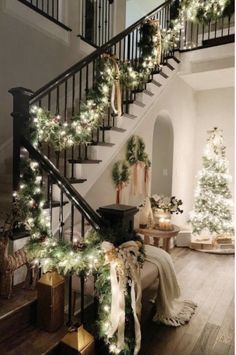 a staircase decorated with christmas trees and garlands