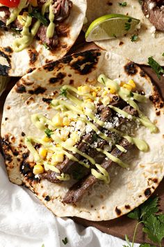 three tacos with meat, corn and green sauce