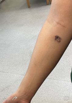 a woman's foot with a small tattoo on the left side of her leg