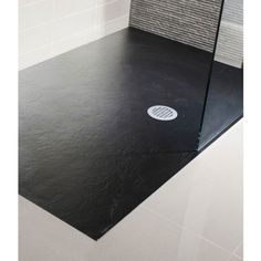 a black and white tiled bathroom with a glass shower door