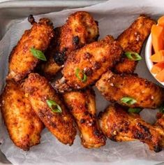 some chicken wings and carrots on a tray