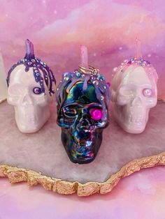 "This listing is for one skull ring holder of your choosing.  Photos have been linked and labeled for your convenience.  Choose your favorite color option!  Descriptions below.  Each skull is made from pearlized coated ceramic.  Genuine colored crystals are used for the ring holder, with cascading colored glue featuring embellishments.   Each skull is approximately 4\" tall by 3.5\" wide. Skull A: White pearl ceramic with pink glitter melt and aura pink quartz crystal. Skull B: White pearl ceram Pearl Ceramic, Pink Quartz Crystal, Aura Pink, Aura Blue, Witchcraft Supplies, Gothic Gifts, Purple Quartz, Hanging Crystals, Wire Wrapping Crystals