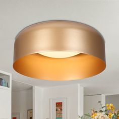 a light that is on the ceiling in a room with white walls and flooring