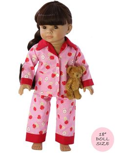 the doll is wearing pajamas and holding a teddy bear