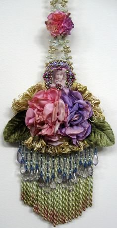 a piece of art made out of beads and flowers