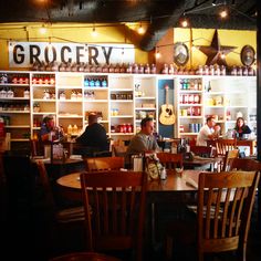 a group of people sitting at tables in a restaurant