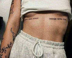 a woman's stomach with tattoos on it and the words, energy never lies