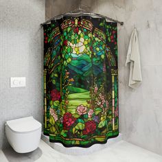 a stained glass shower curtain in a bathroom next to a toilet and window with flowers on it