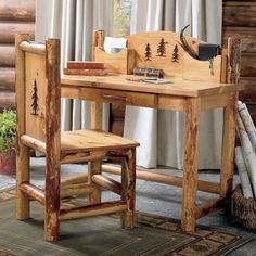 a wooden desk and chair in front of a log cabin window with white drapes