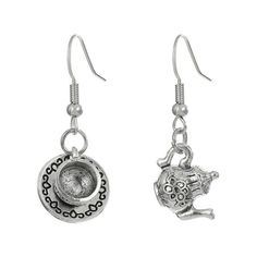 two silver earrings with charms hanging from them