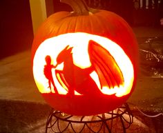 a carved pumpkin with an image of a dragon on it