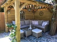 an outdoor living area with patio furniture and string lights