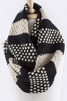 a black and white knitted scarf on a mannequin