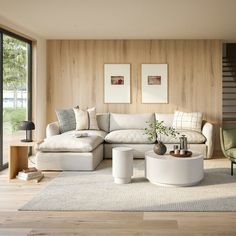 a living room with white furniture and wooden walls