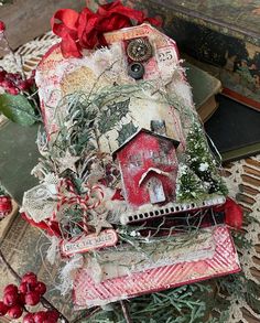 a birdhouse is sitting on top of some christmas decorations