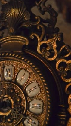 an ornate clock with roman numerals on the face and hands is lit up